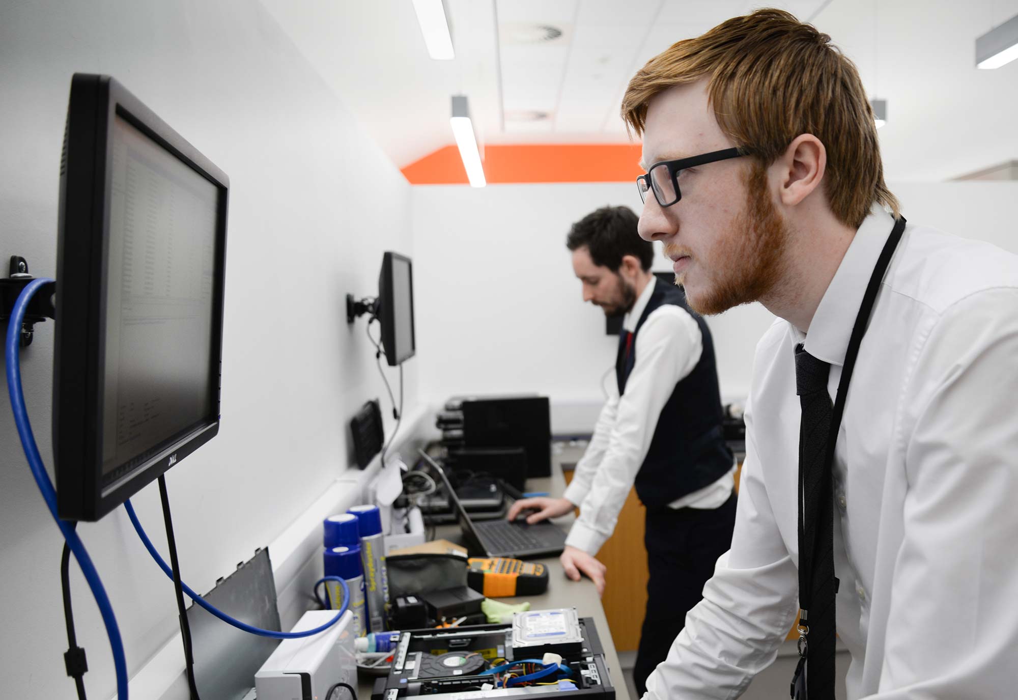 two male members of IT support staff working at Greaves West and Ayre Office