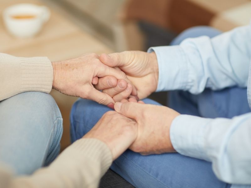 Elderly couple holding hands